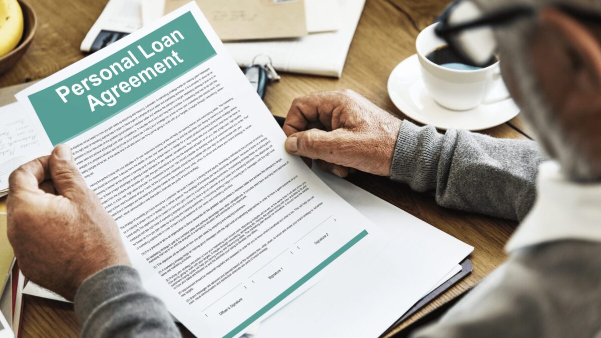 a person reviews personal loan agreement contract