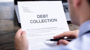 a person reads a debt collection letter