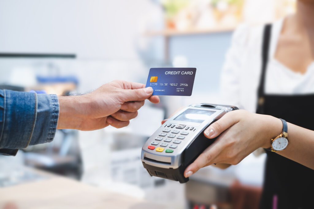 Close up of customer using credit card system to purchase a car | Auto repair financing options