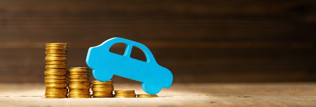 Blue model car drives down slope of decreasing coin stacks | Auto repair financing options