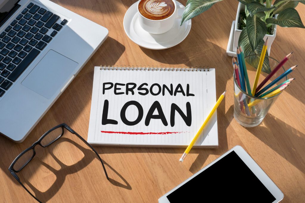 Personal loans written on spiral notebook on cluttered desk | Auto repair financing options