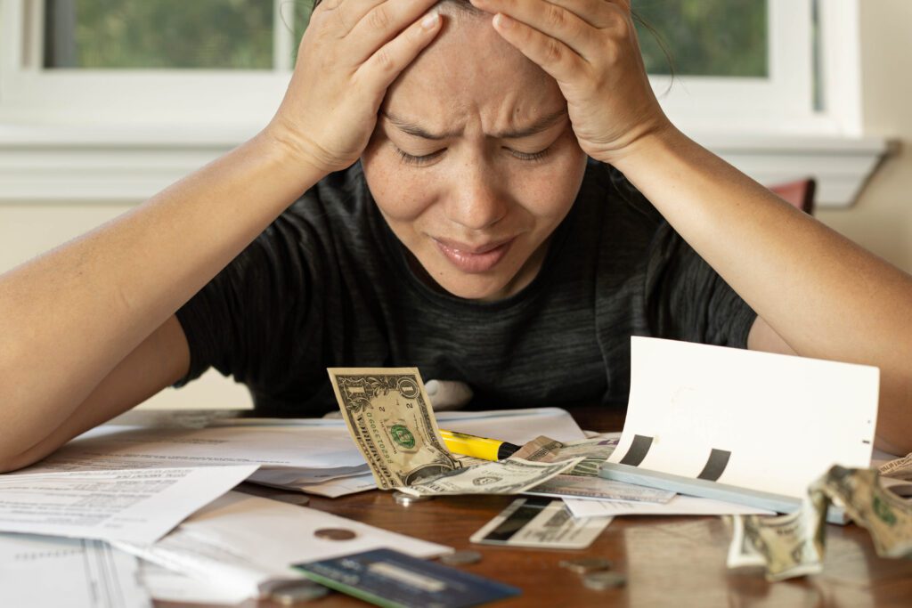 A stressed woman without emergency savings | Emergency reasons to borrow money