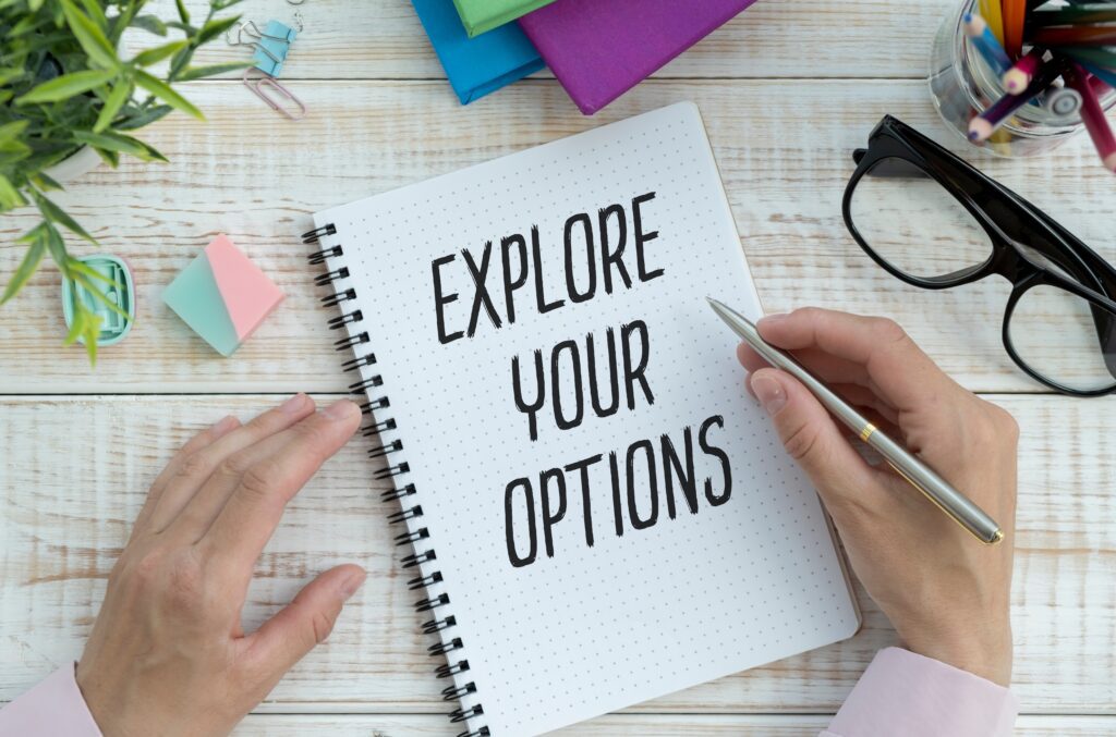 Person writing on notebook prompting reader to explore your options | Funeral financing options
