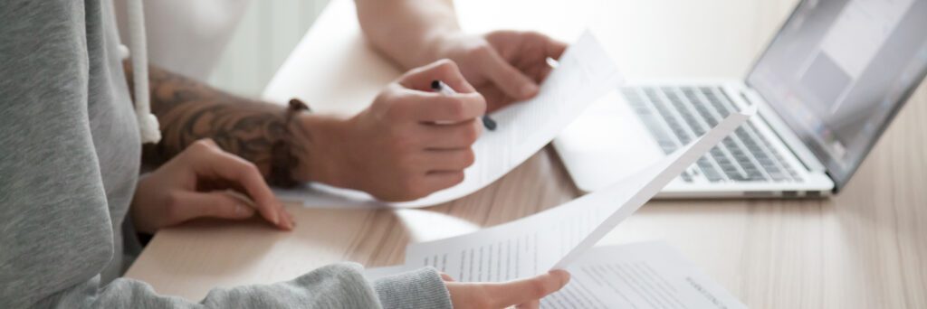 A couple carefully reviewing a loan agreement | How do emergency loans work?