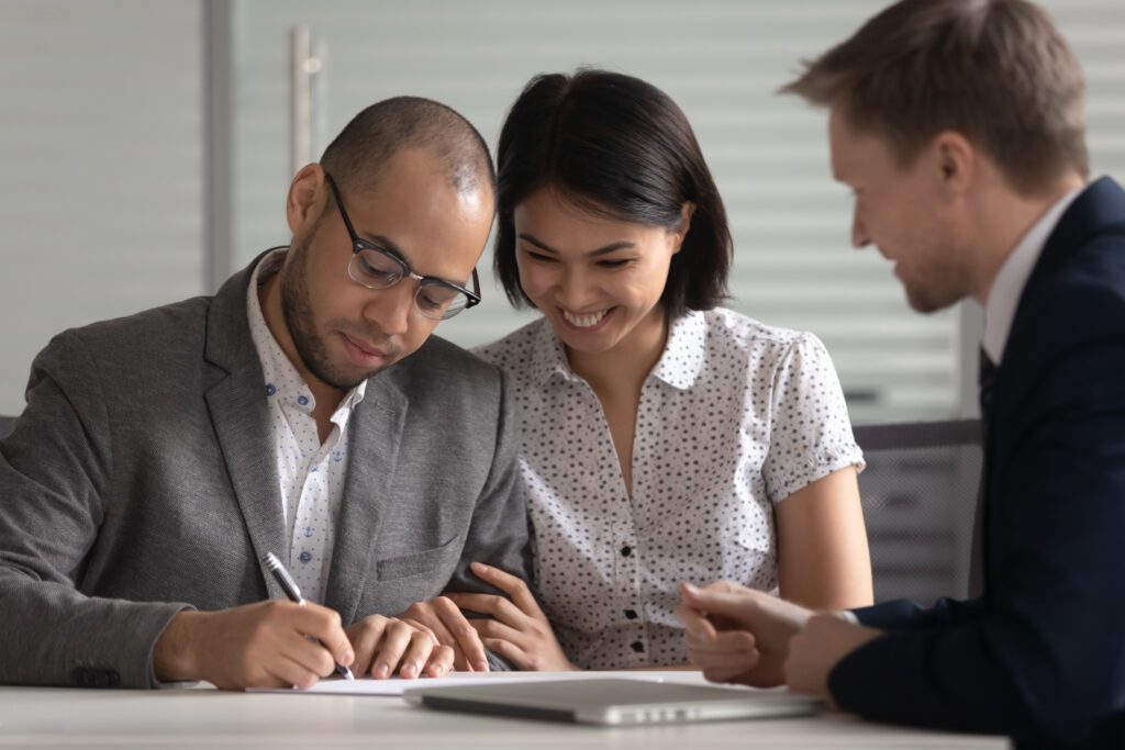 A couple signing their loan agreement | How do emergency loans work?