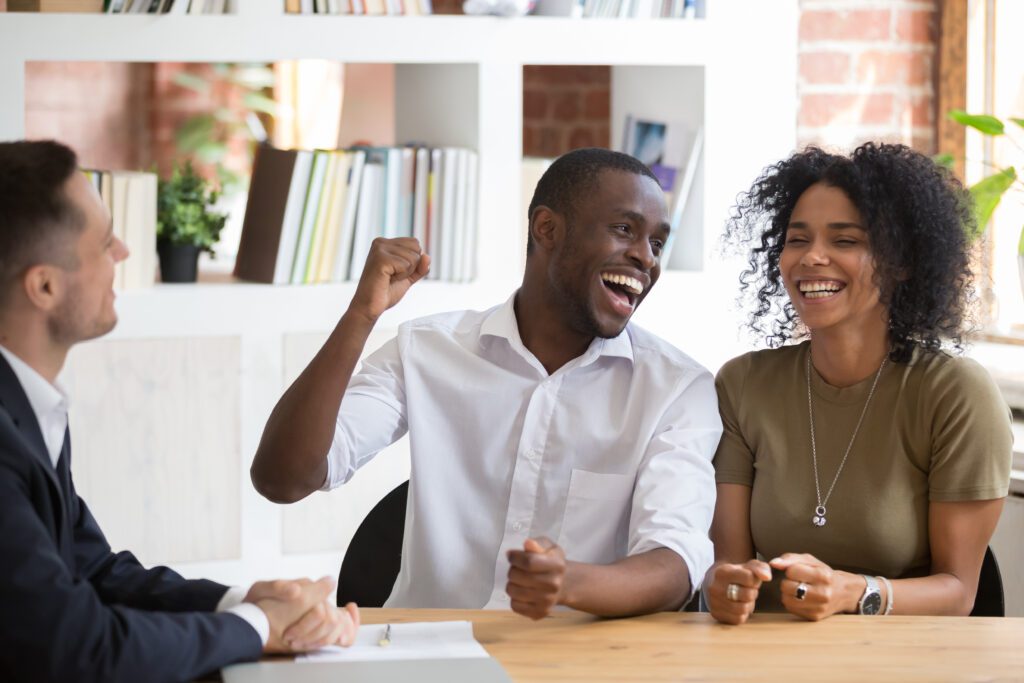 An excited couple who just received a loan approval | How does a relocation loan work?