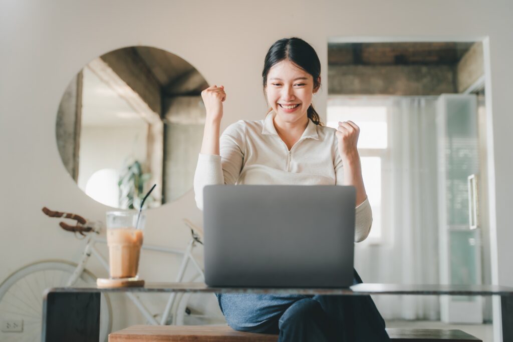 Woman cheers in excitement as she receives her loan decision | Veterinarian loan financing