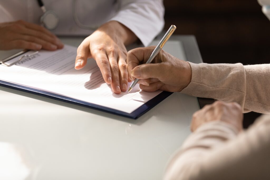 Woman signs emergency loan contract after researching options | Planning for unexpected expenses