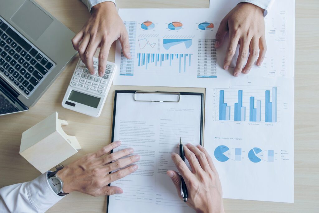 Two people reviewing loan trend documents | Personal loan statistics