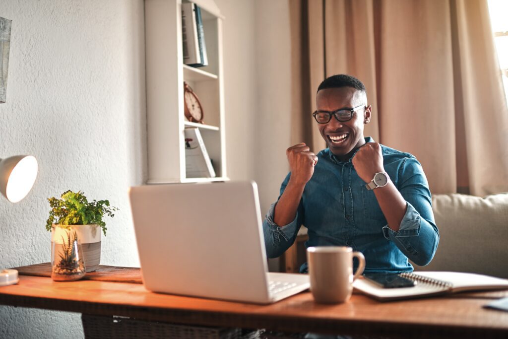 An excited young man receiving a loan approval | Personal loan statistics
