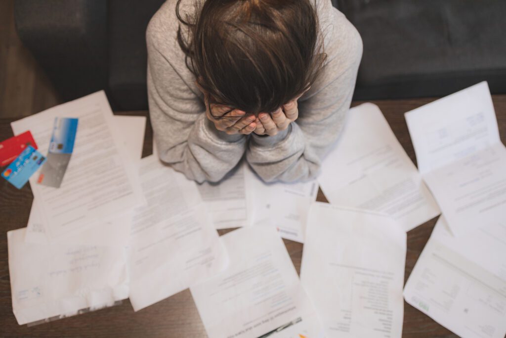 A young woman stressed out over her debt | Personal loan statistics